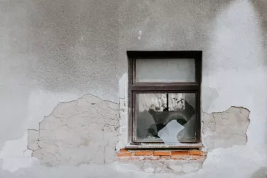 fenêtre d'une maison et mur abîmé