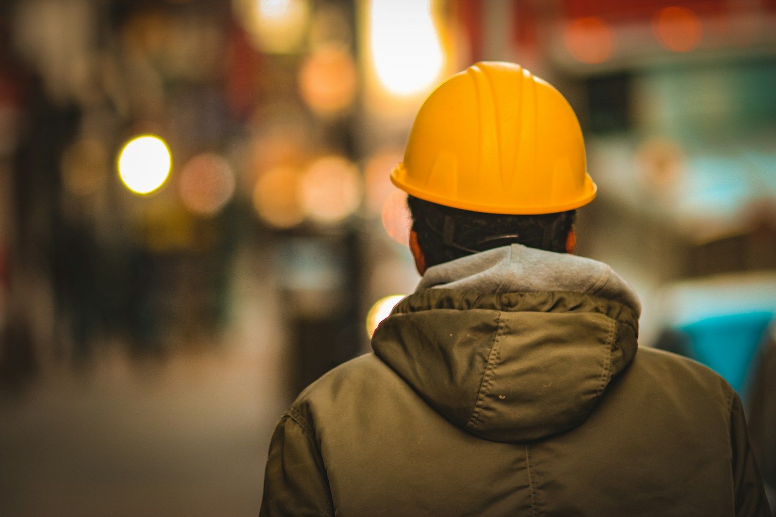 Personne de dos avec un casque de chantier jaune