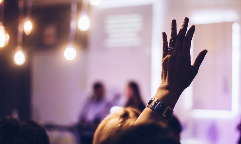 person raising hand